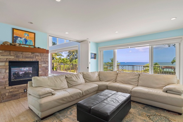 L-shaped couches with fireplace, a tv and Ocean views