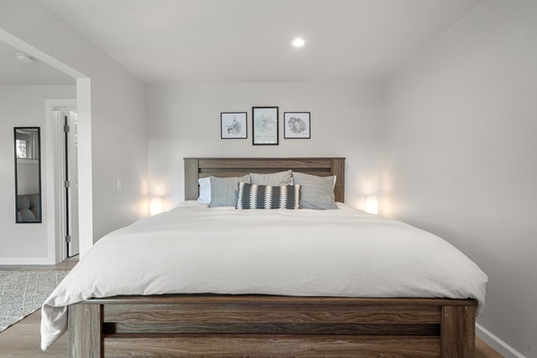 Inviting bedroom with a cozy king-sized bed and tasteful, minimalist decor.