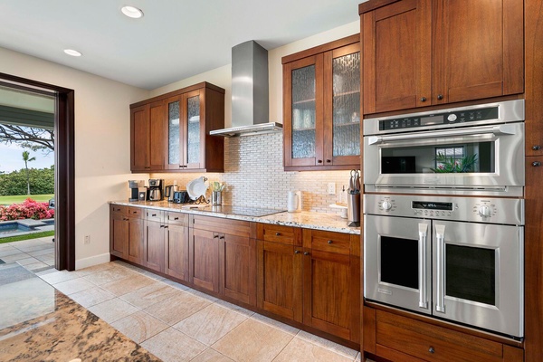 Rich wooden cabinets and stainless steel appliances.