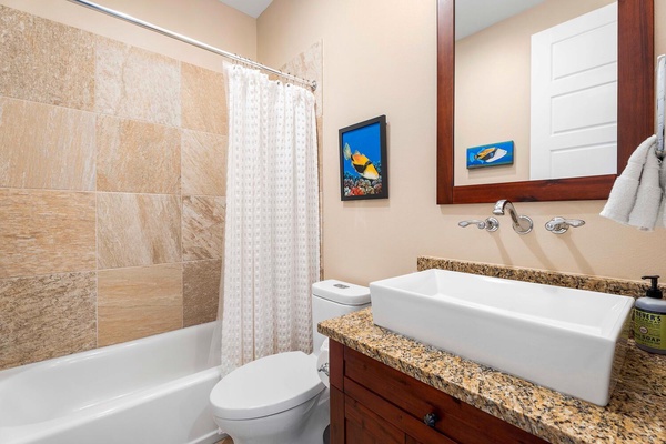 Ensuite bathroom with a single vanity and a shower/tub combo.