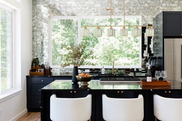 Luxury kitchen and magical backsplash frames your wooded view in this lovely home.