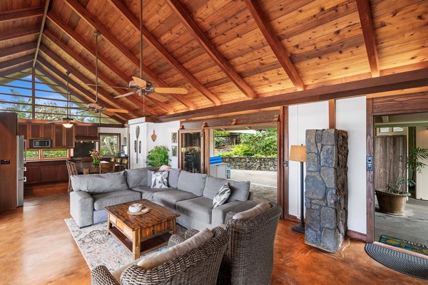 The living room features a comfortable seating area and wooden ceilings.