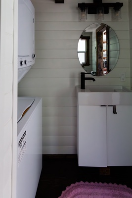 Bathroom sink beside the compact washer/dryer.