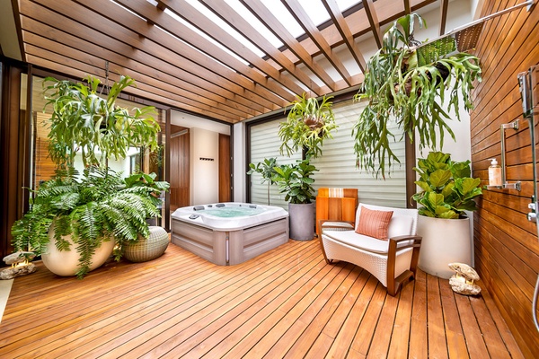 Unwind in the private hot tub with plant-filled deck area, perfect for ultimate relaxation.