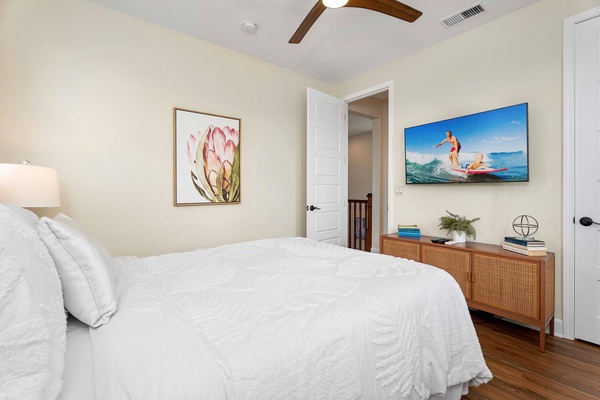The third guest bedroom is adorned with vibrant artwork and serene decor.