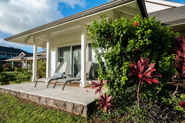 Primary Bedroom Lanai with lounge chairs and golf course and sunset views