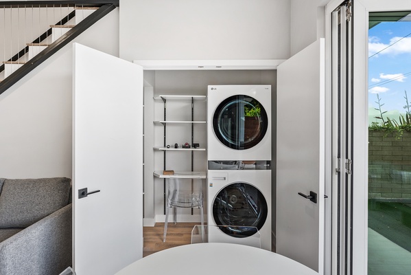 Full stackable washer / dryer tucked away off the kitchen.