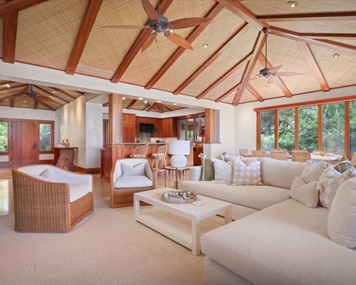 Wide view of the great room & foyer featuring soaring vaulted ceilings