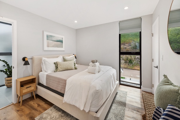 Guest bedroom with a Queen size bed and outdoor views.