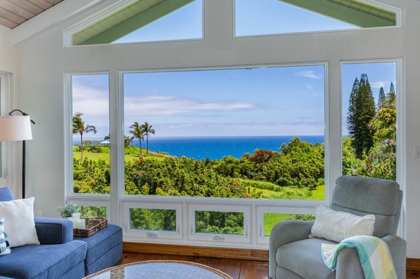 Breathtaking view from Wai Lani's  living room overlooking the ocean and lush greenery.