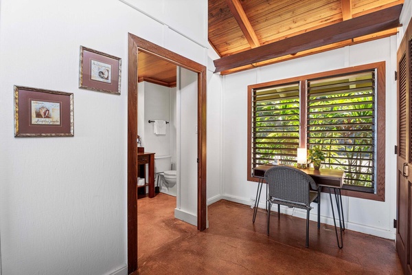 A desk by the window, perfect for a quiet workspace or enjoying the garden view.