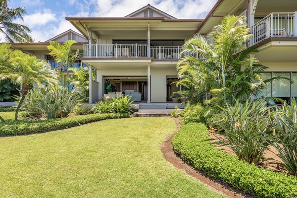 Wide view of backyard showcasing upper and lower decks and private grassy lawn area.