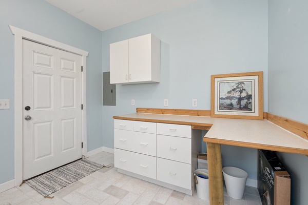 Laundry area with plenty of storage cabinets