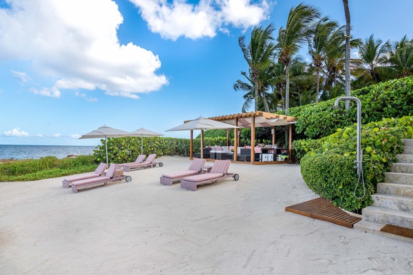 Cozy seating, shade, and easy access to the sandy shore and turquoise ocean.