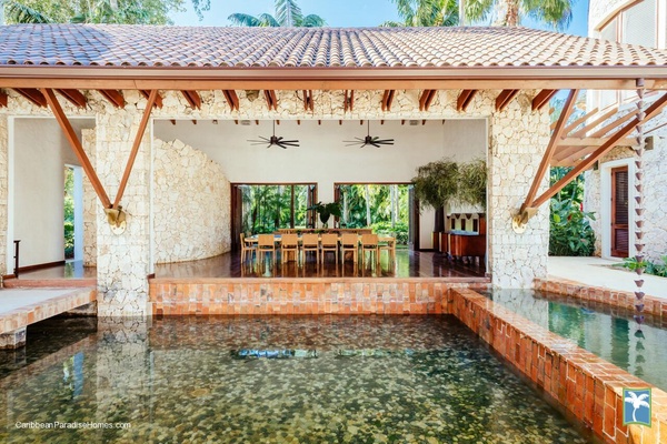 Dining space overlooking a tranquil water feature.