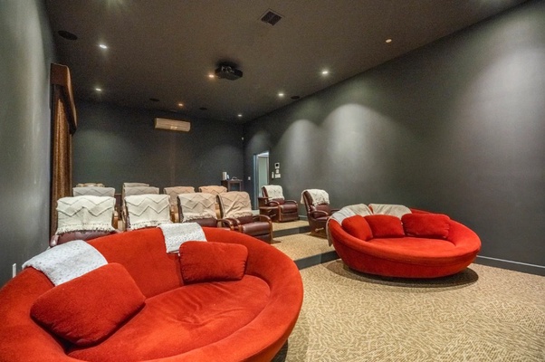Private home theater with plush seating, designed for the ultimate movie night experience in the comfort of your own home.