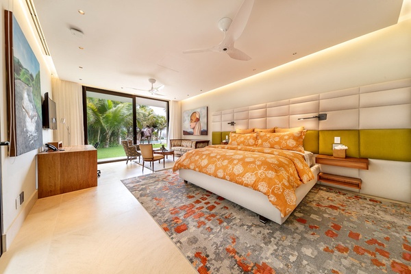 Cozy guest bedroom, with a comfortable king-size bed, vibrant accents, and floor-to-ceiling windows.