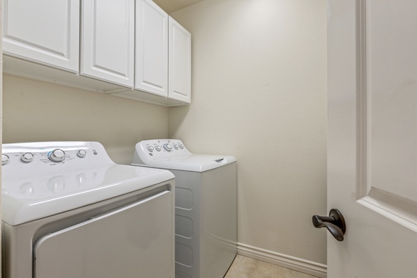 Dedicated laundry room with oversized washer and dryer and supplied laundry
products.