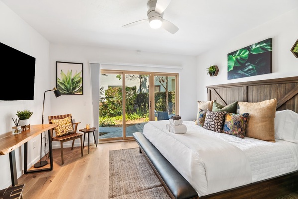 Bedroom #2 with King size bed, writing desk, seating area and private patio access and ocean view