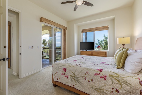 Spacious primary bedroom with ocean views, lanai access and en suite bath.
