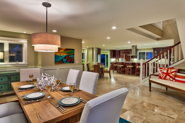 The spacious and elegant dining room, with a view of the kitchen.