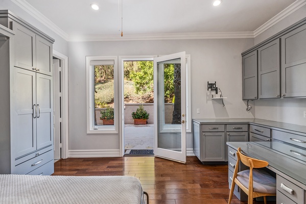 French doors leading out to the side patio, outdoor kitchen and pool areas.