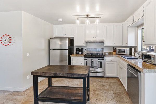 Plenty of prep spaces, accented with white cabinetry to store your kitchen essentials.