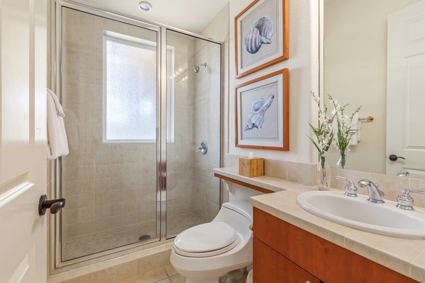 Second bath, adjacent to guest bedroom, with walk-in shower.