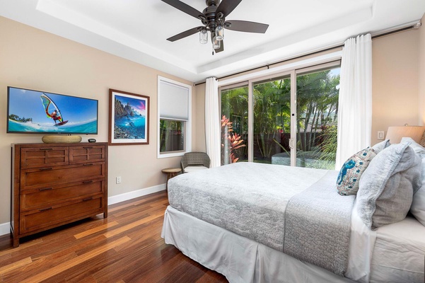 The guest bedroom has TV and access to the garden.