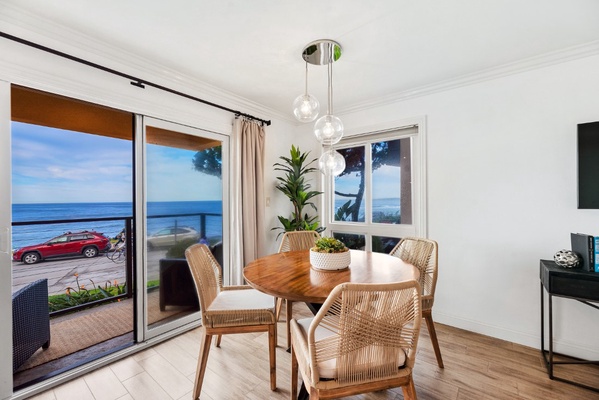 The dining table seats four guests comfortably, and is situated right next to the patio, allowing you to enjoy al fresco dining while taking in the panoramic ocean views.