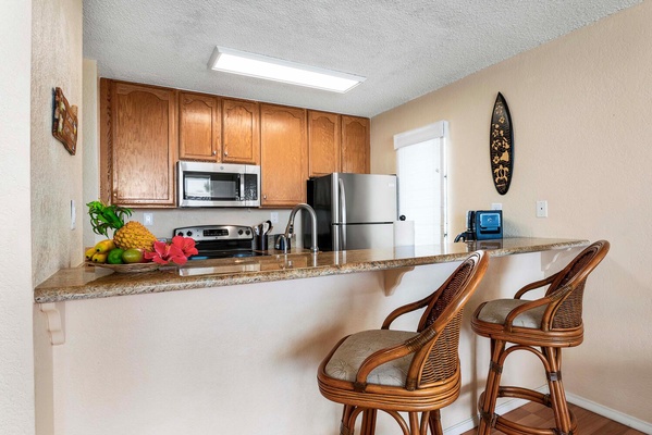 Kitchen has breakfast bar seating.