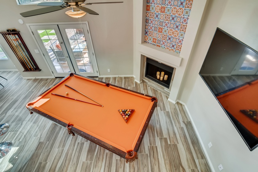 The patio leads to the great room equipped with pool table and 55" smart TV for the perfect gaming area!