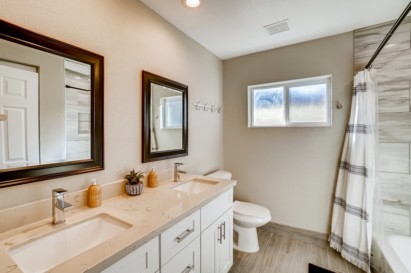 Dual vanities and a bathtub in the guest bathroom