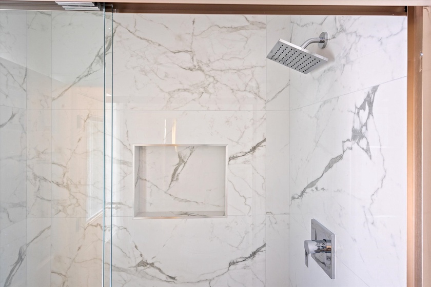 Beautiful marble shower in primary bathroom.