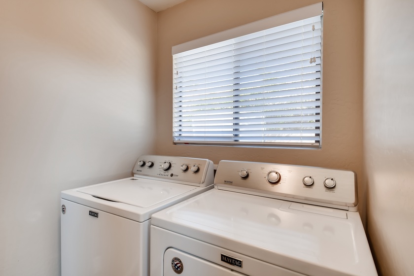 In house washer and dryer stocked with laundry soap bleach and dryer sheets for your convenience
