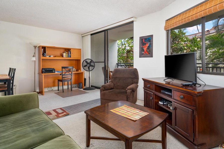 Living room with work area and lanai access