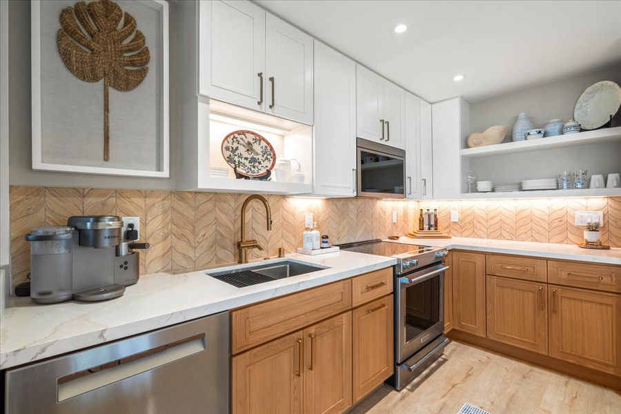 Stainless steel appliances with elegant tiled backsplash