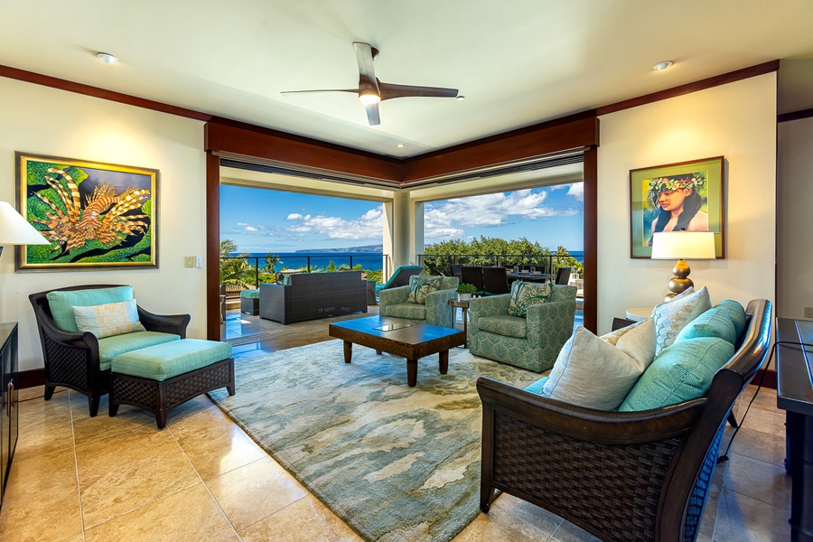 Living room has two glass walls that open to bring Maui in.