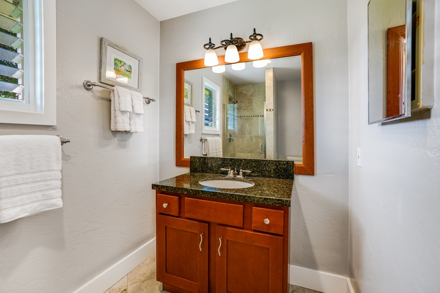The shared bathroom across the guest bedroom, complete with all the essentials for a rejuvenating retreat.