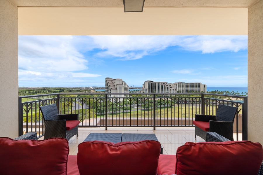 Your private lanai offers panoramic views over lush landscapes and distant coastline, perfect for morning coffee or sunset relaxation.