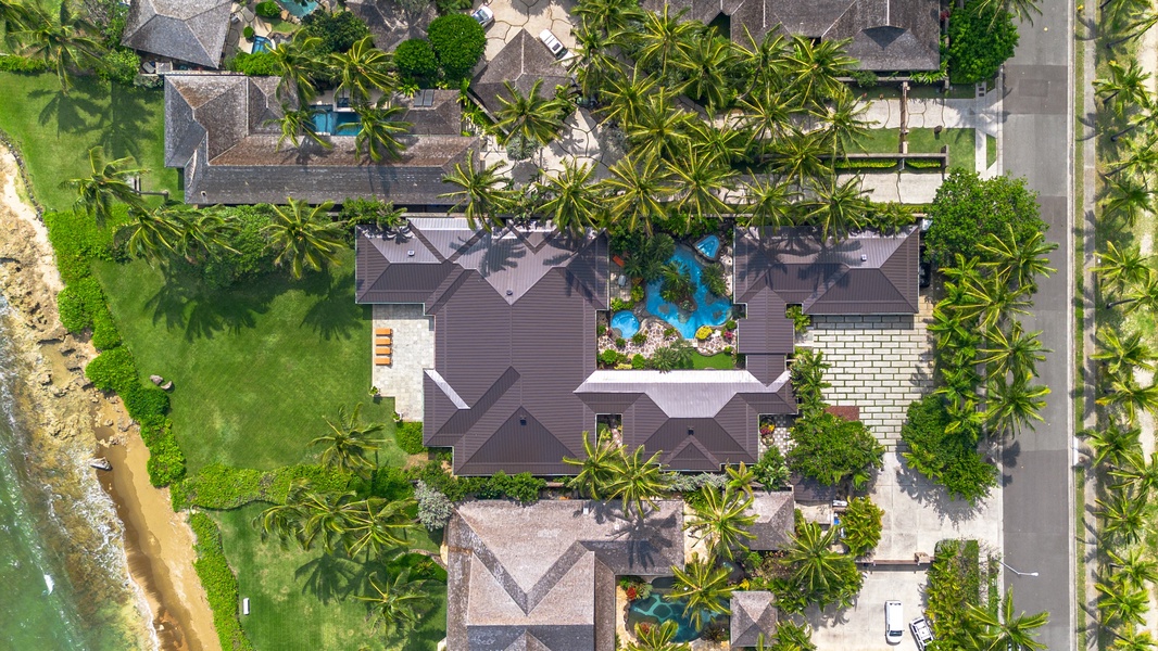 Overhead layout reveals seamless indoor‑outdoor flow, pool, and ocean frontage.