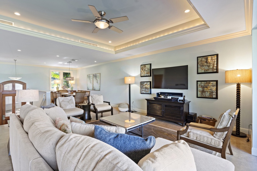 Unwind in the spacious living room at Wailea Hoolei 93-3, with comfortable seating, a large TV, and soft lighting.