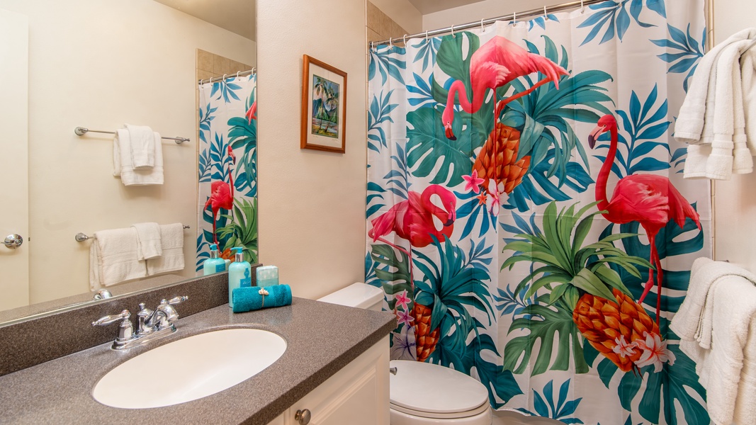 The second guest bathroom with bright tropical patterns and a shower.