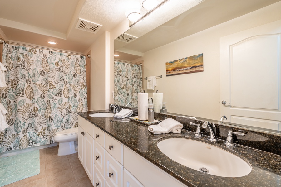 Spacious ensuite with dual sinks, ample vanity space and a walk-in shower.