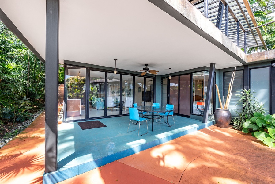 A shaded outdoor lanai with seating, perfect for dining or relaxing in the island breeze.