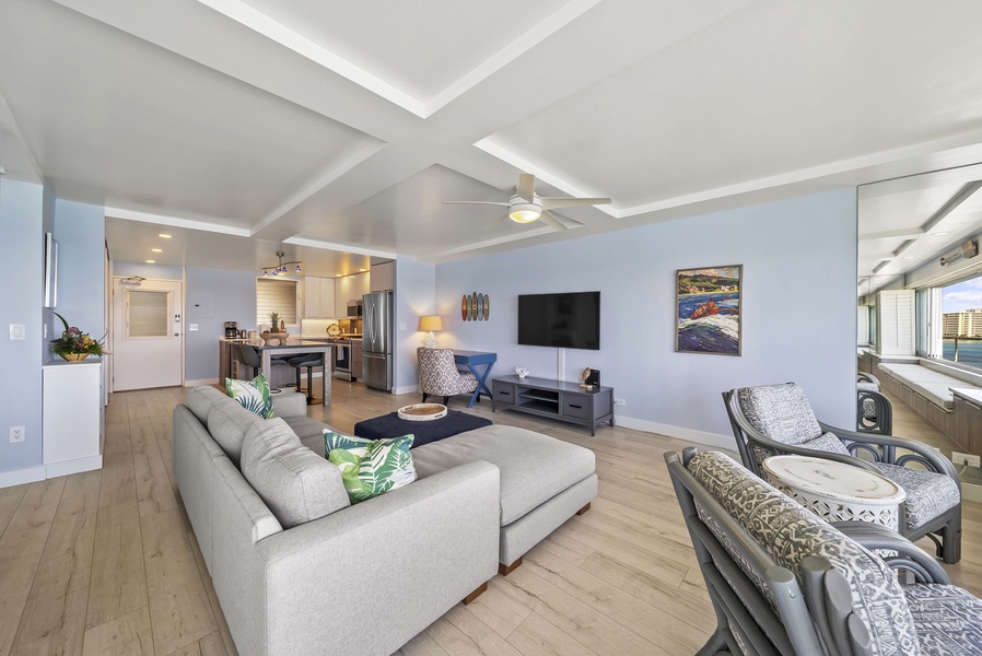 Relax in your bright, modern living space with comfortable seating and entertainment center, perfectly connected to a full kitchen.