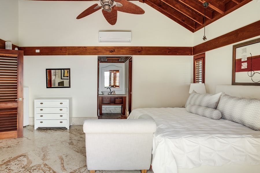 The third guest suite features a king sized bed, footboard bench and split AC.