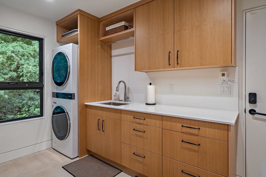 The laundry area for convenience adjacent to the shared bathroom.