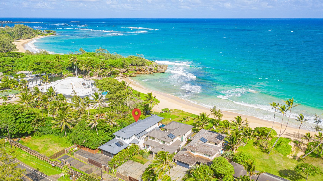 Aerial view highlighting the property’s prime beachfront location, just steps from the sandy shores and turquoise waters.