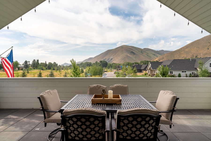 The outdoor dining table on the upper-level balcony offers amazing mountain views